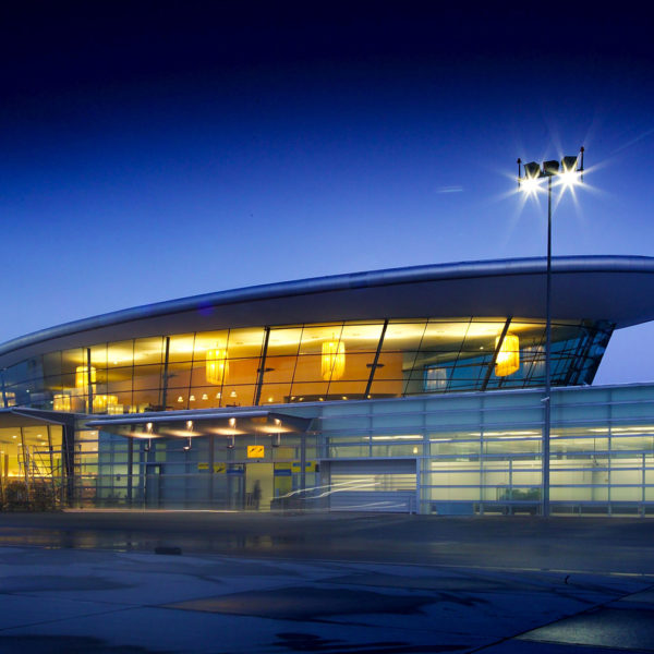 Graz Airport at night, with a lit control tower in the background.