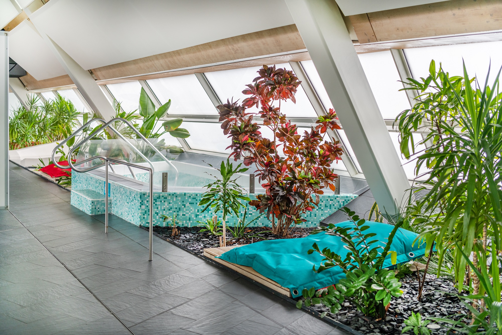 A whirlpool in the wellness area of the Auster, surrounded by plants and a blue beanbag chair.