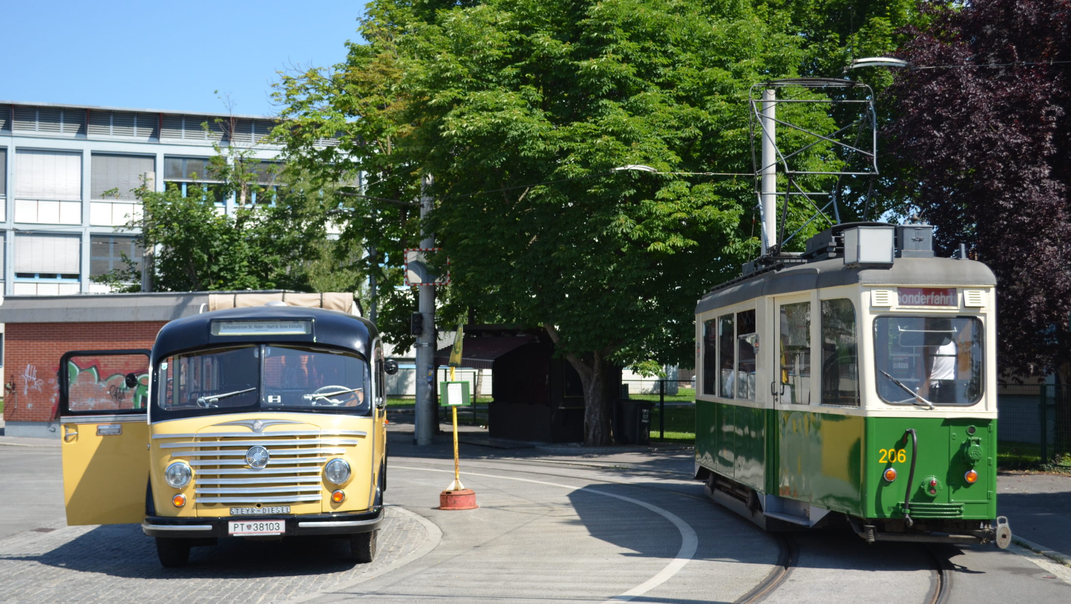 Old bus and old tram stand side by side at the St. Peter-Schulzentrum stop