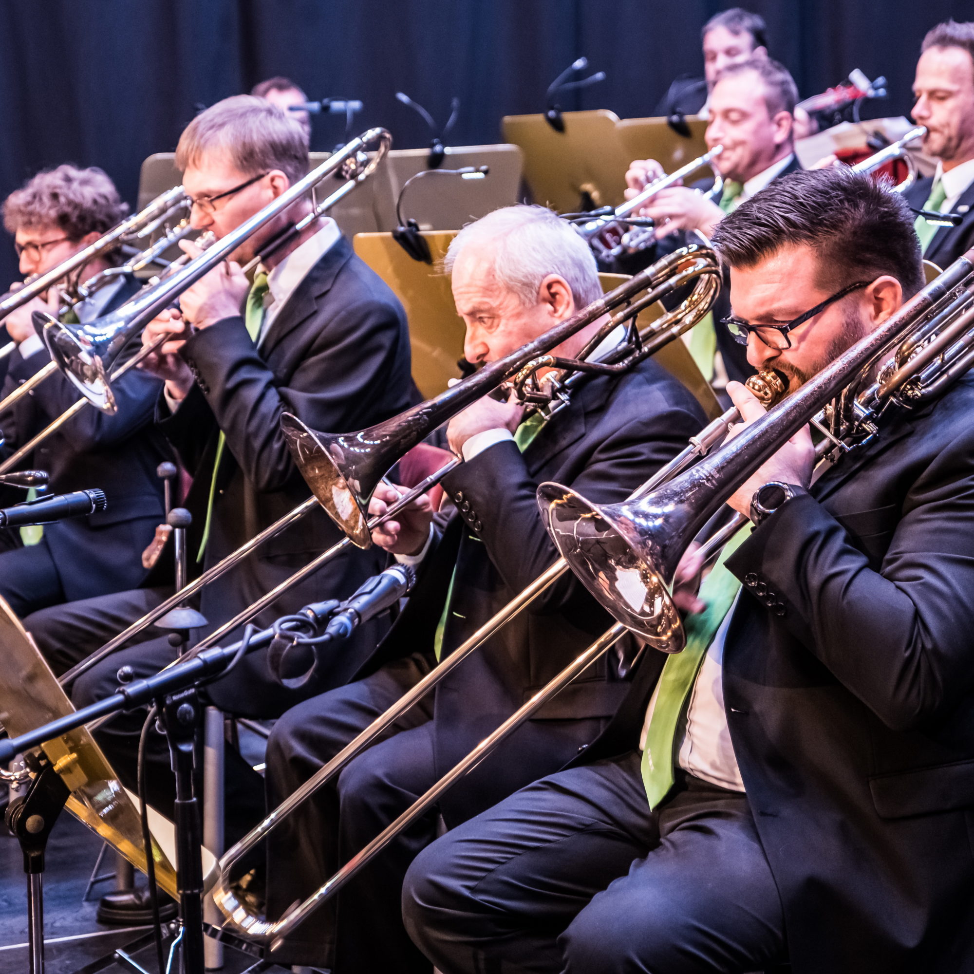 The trombone section of the Big Band Graz performs on stage.