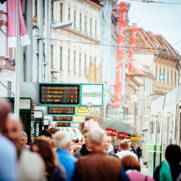 Passers-by at the Graz Linien stop Hauptplatz