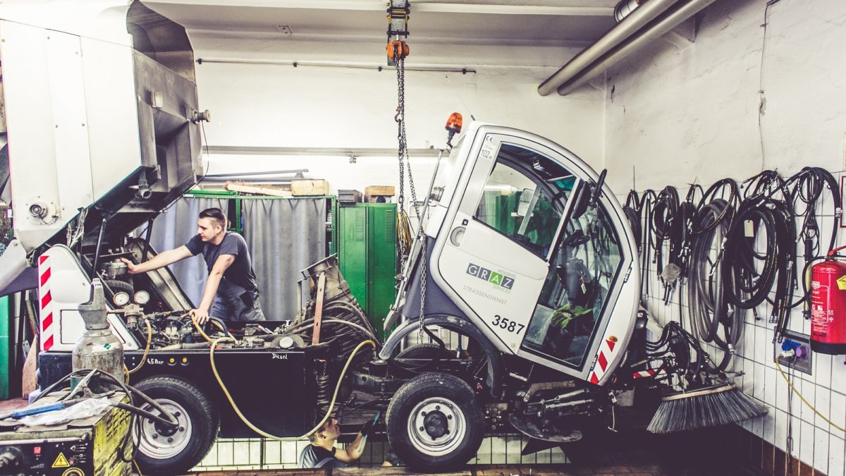Municipal sweeper being repaired in municipal workshop