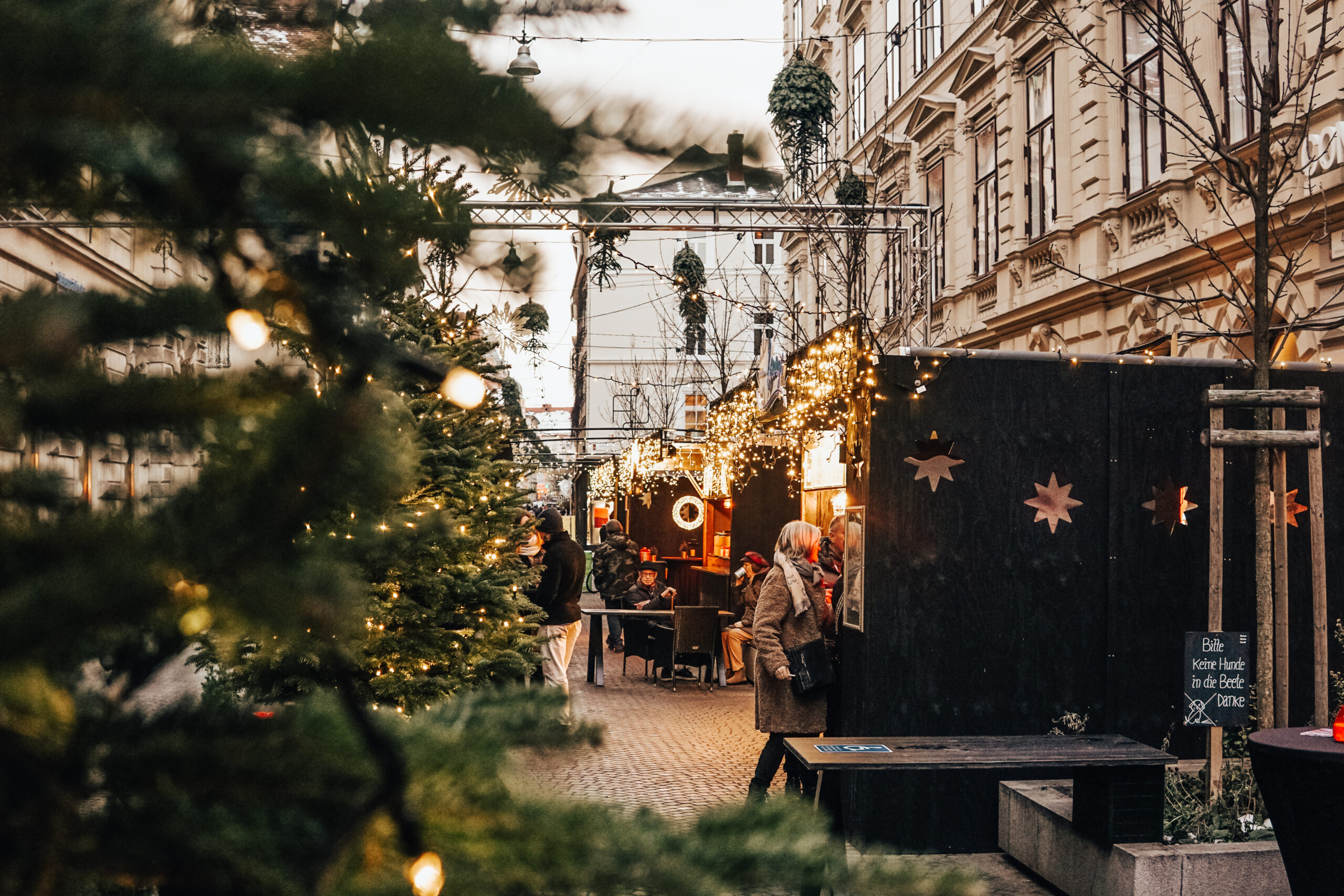 Street view of the Christmas market in Graz, Austria with stalls and visitors.