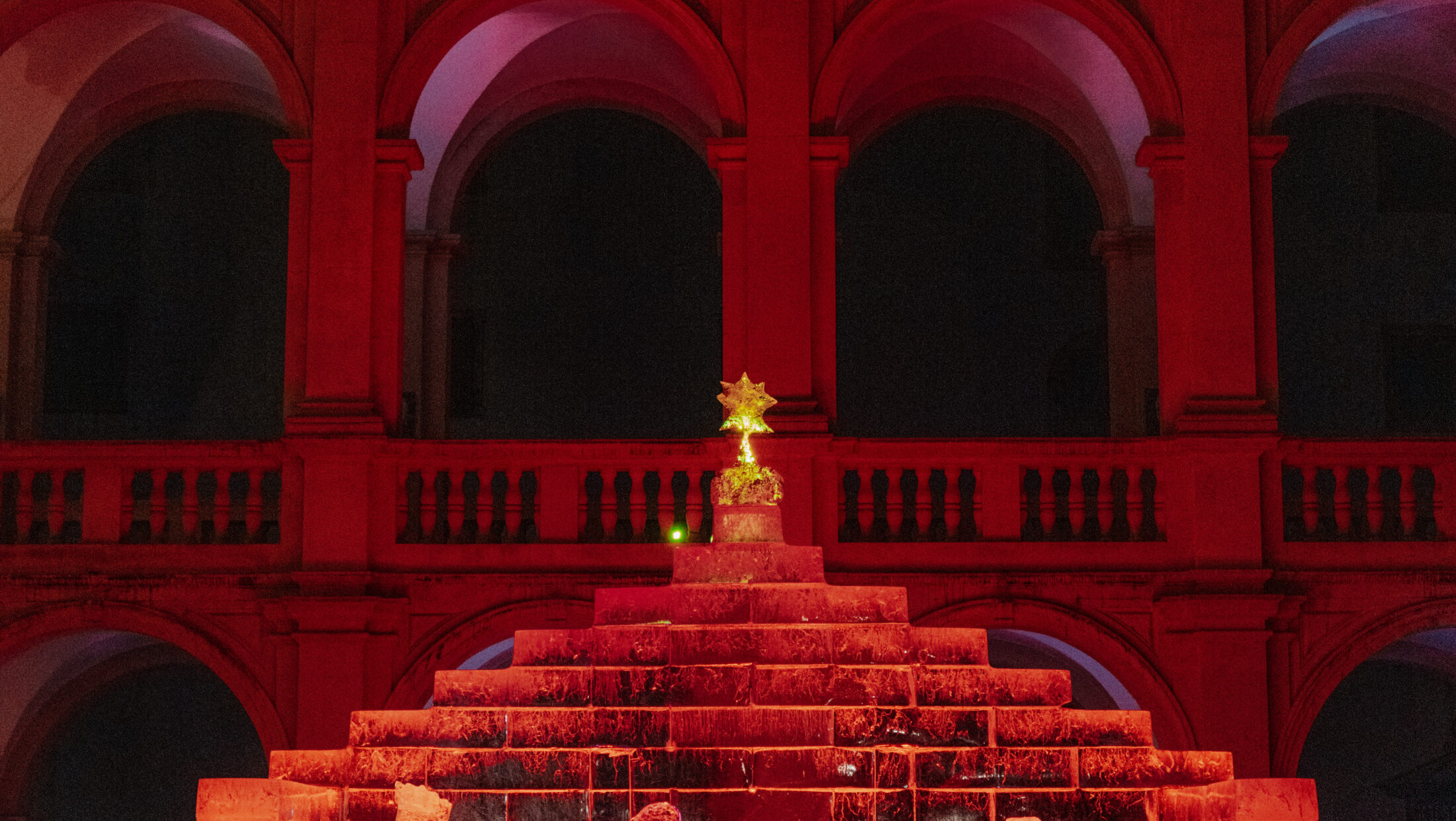 Illuminated ice nativity scene in the Landhaushof in Graz at night.